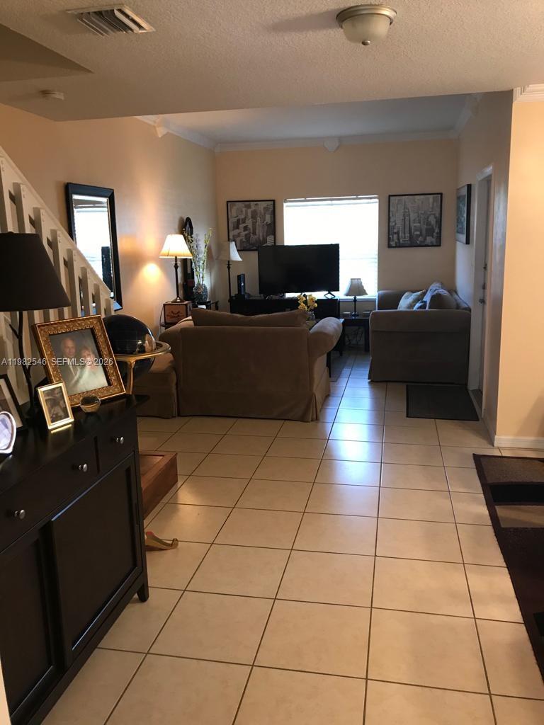 2142 Siena Way Hollywood, FL 33021 - Photo 5 of 13 a living room with furniture and a flat screen tv
