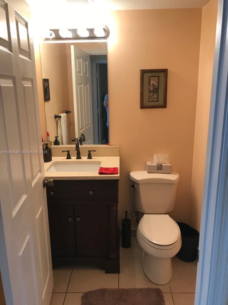 2142 Siena Way Hollywood, FL 33021 - Photo 6 of 13 a bathroom with a toilet a sink and mirror