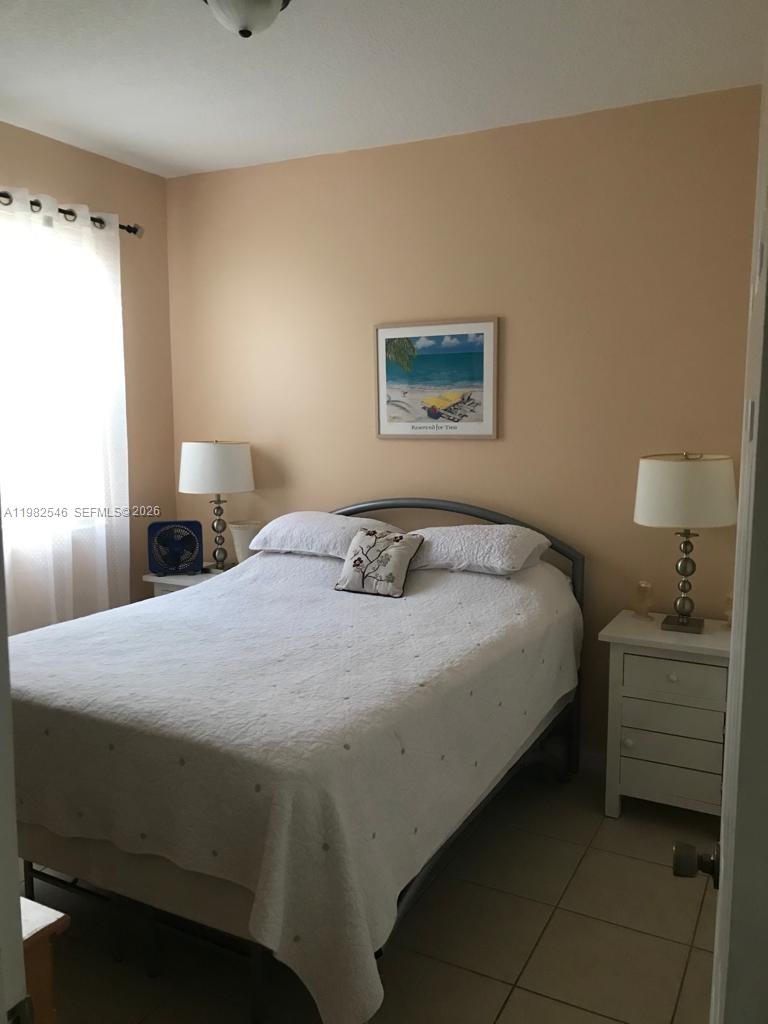 2142 Siena Way Hollywood, FL 33021 - Photo 7 of 13 a bedroom with a bed and a lamp on the dresser