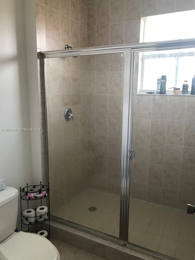2142 Siena Way Hollywood, FL 33021 - Photo 9 of 13 a bathroom with a shower a toilet and a sink