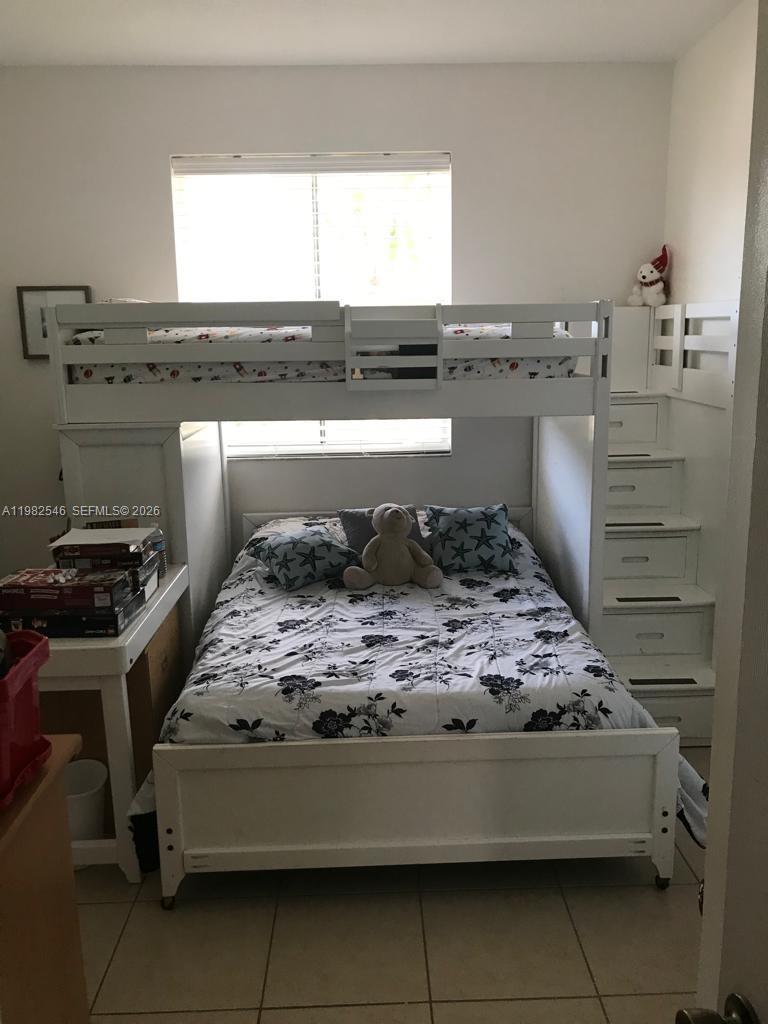 2142 Siena Way Hollywood, FL 33021 - Photo 10 of 13 a bedroom with a bed and a window