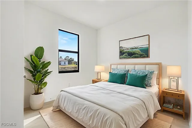 a bedroom with bed and a potted plant
