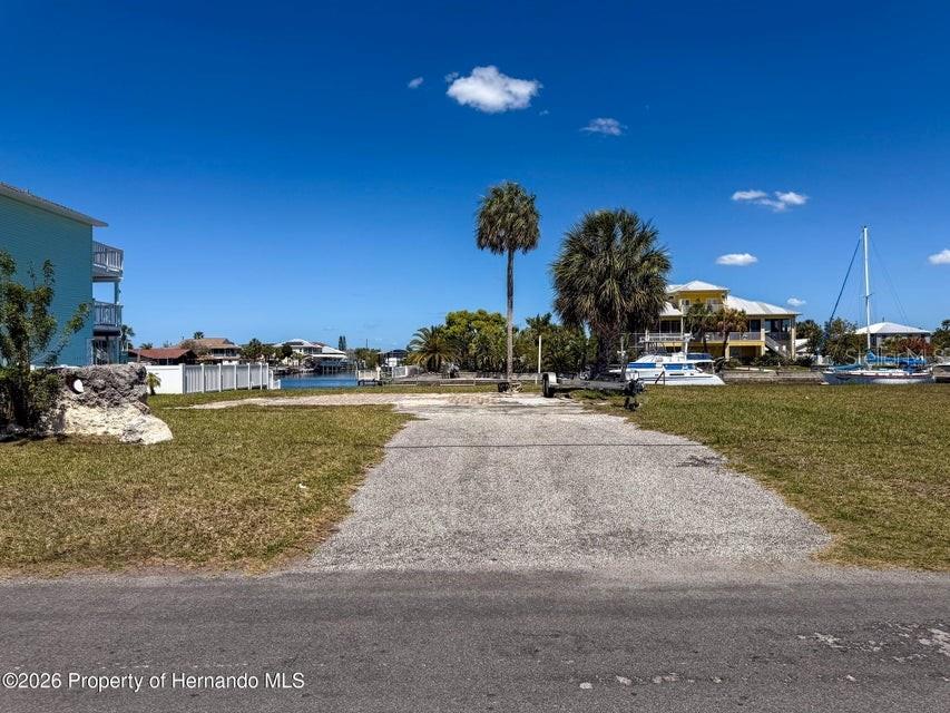 3473 Gulf Coast Drive Hernando Beach, FL 34607 - Photo 6 of 50 a view of a swimming pool with an outdoor seating and a yard
