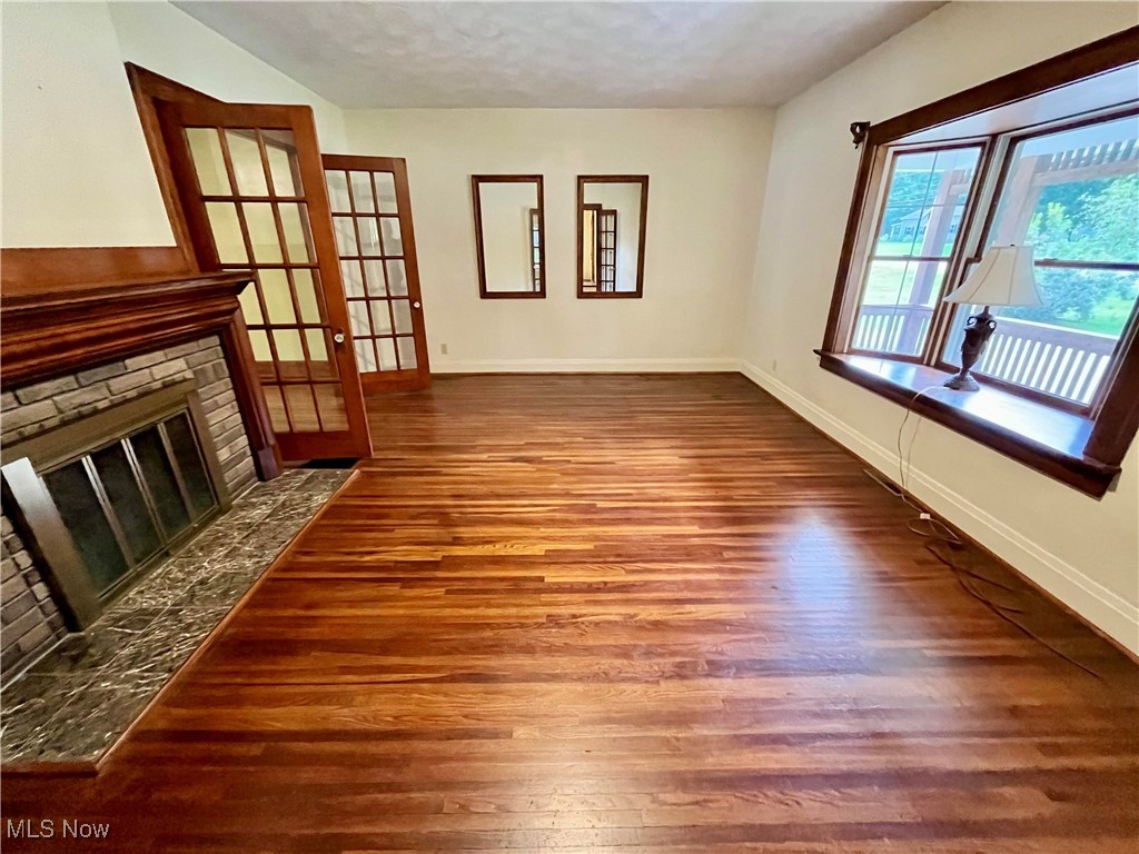 6543 North Ridge Road East Geneva, OH 44041 - Photo 5 of 49 Unfurnished living room featuring a textured ceiling and hardwood / wood-style floors