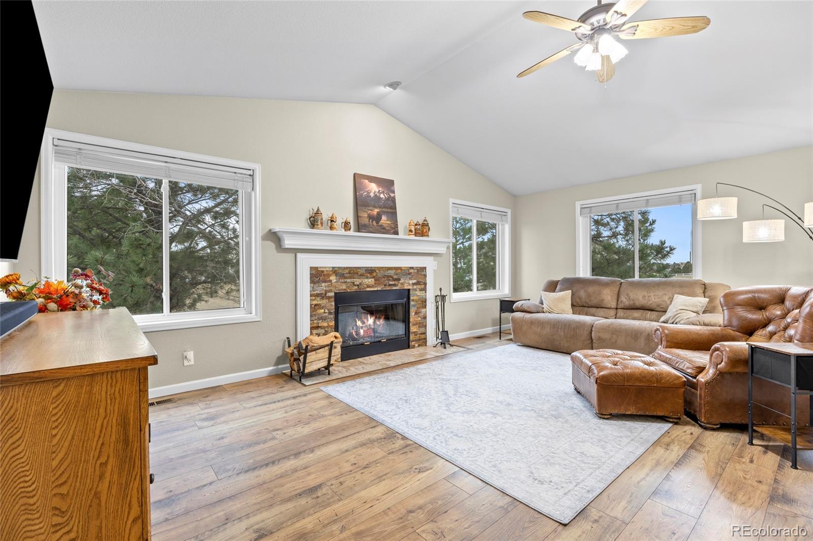 42865 Vista Ridge Road Parker, CO 80138 - Photo 11 of 50 a living room with furniture large window and a fireplace