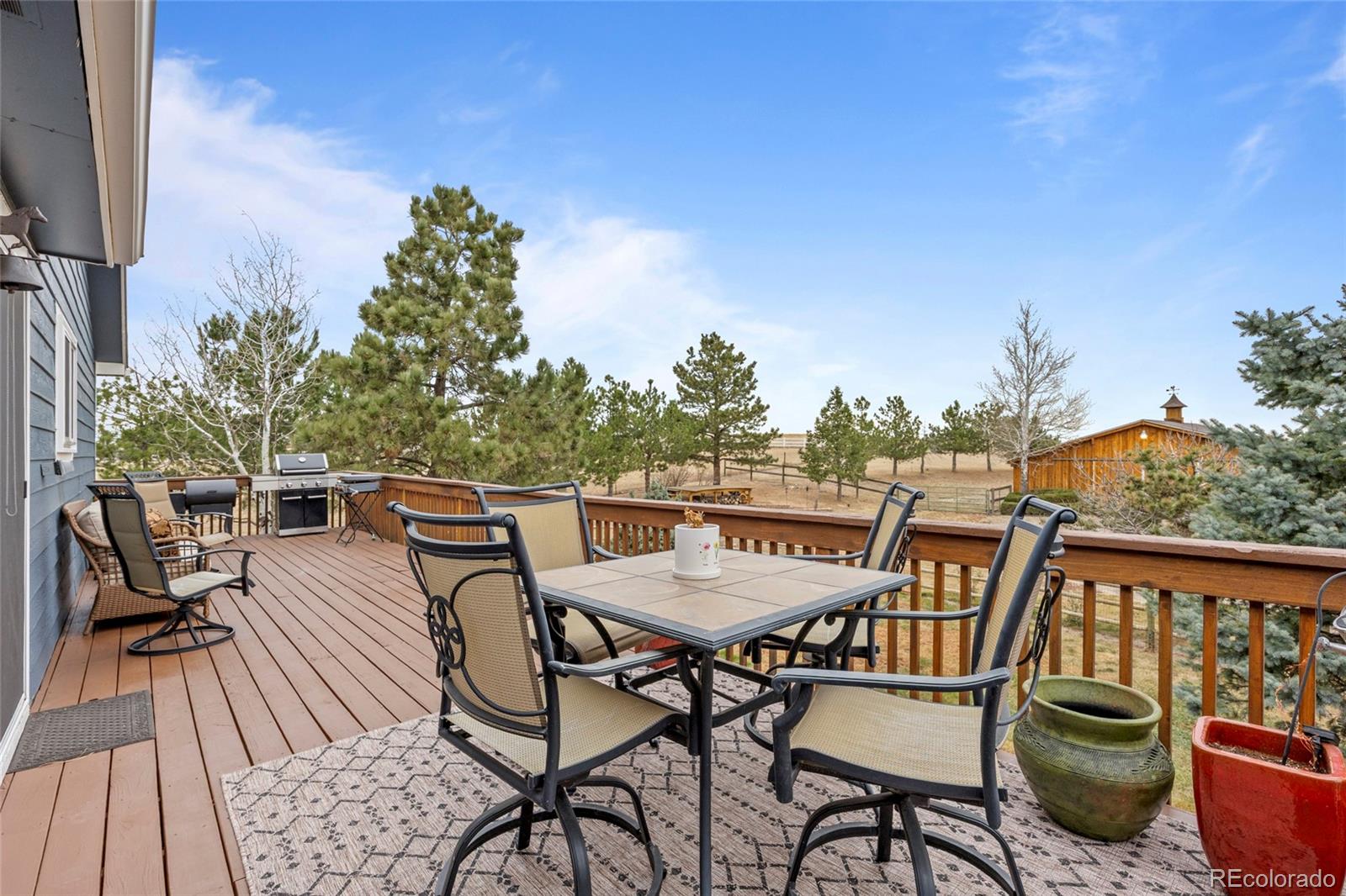 42865 Vista Ridge Road Parker, CO 80138 - Photo 15 of 50 a balcony with wooden floor table and chairs