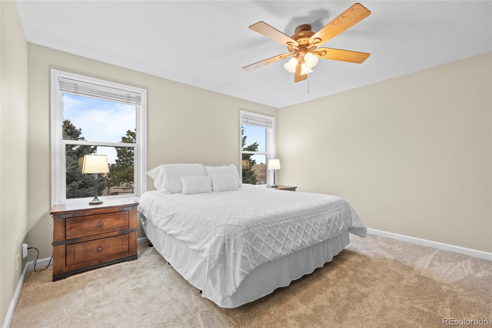 42865 Vista Ridge Road Parker, CO 80138 - Photo 19 of 50 a spacious bedroom with a bed and a chandelier