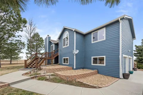 a brick building with a large tree