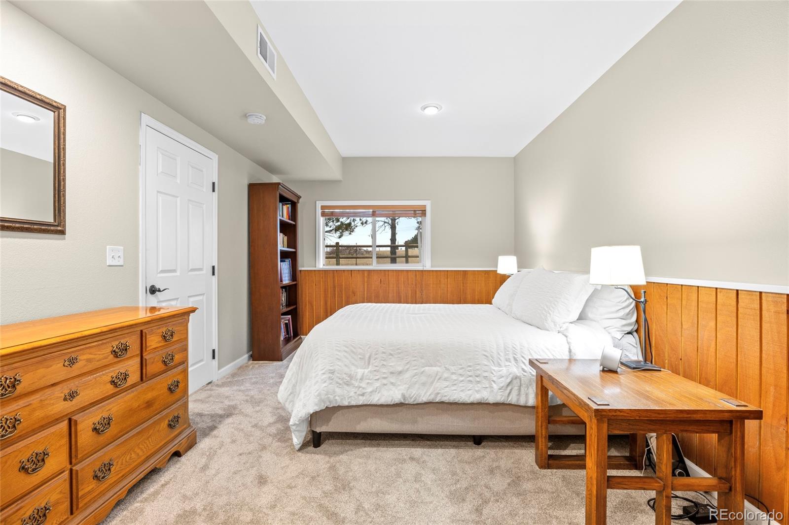 42865 Vista Ridge Road Parker, CO 80138 - Photo 31 of 50 a bedroom with a bed and dresser with mirror