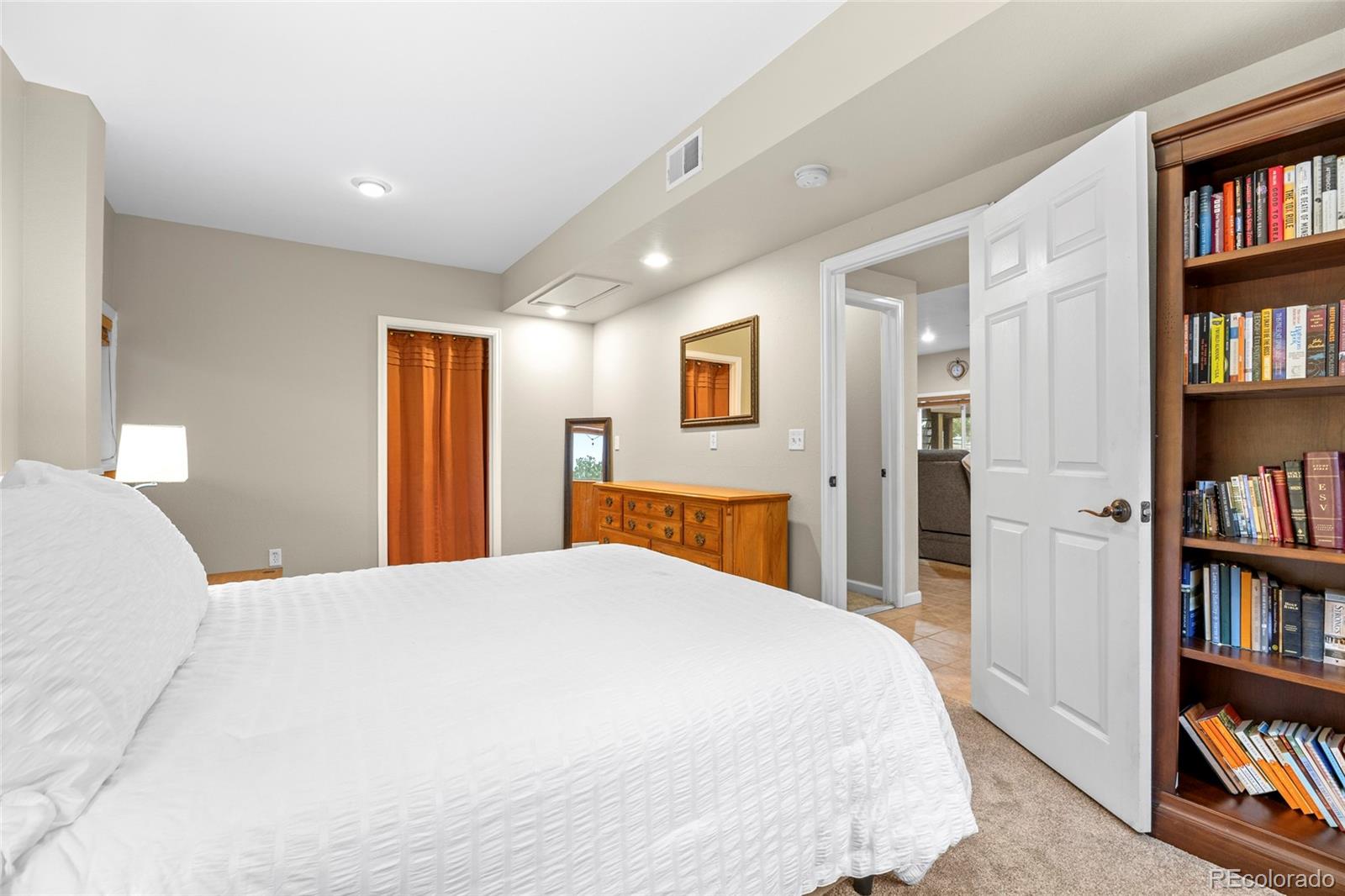 42865 Vista Ridge Road Parker, CO 80138 - Photo 32 of 50 a bedroom with a bed and a book shelf