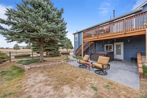 a view of house with outdoor seating area