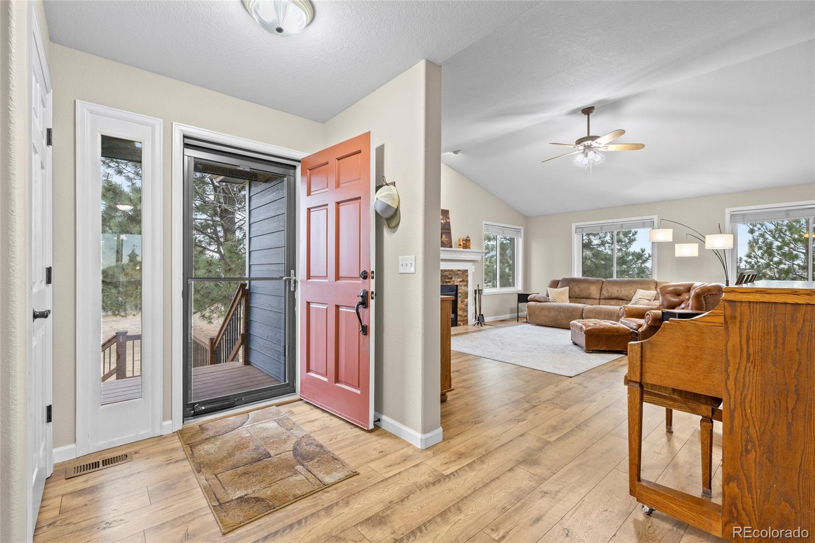 42865 Vista Ridge Road Parker, CO 80138 - Photo 7 of 50 a living room with furniture a chandelier and a flat screen tv