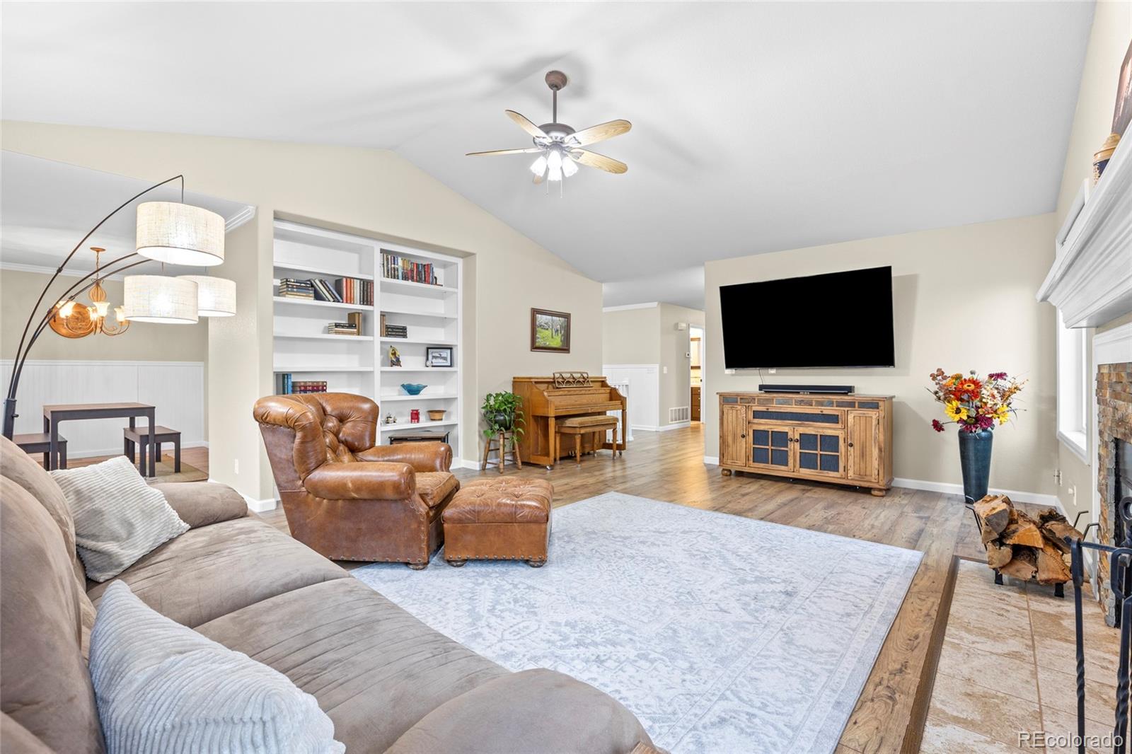 42865 Vista Ridge Road Parker, CO 80138 - Photo 8 of 50 a living room with furniture and a flat screen tv