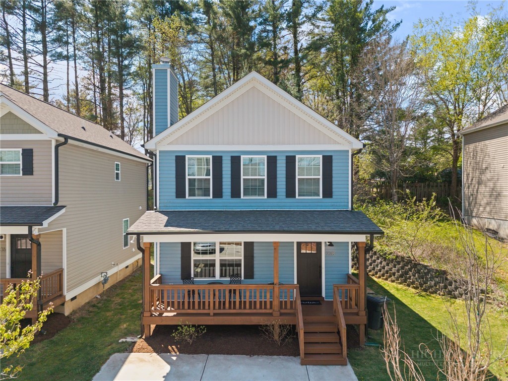 a view of house with a yard and sitting area