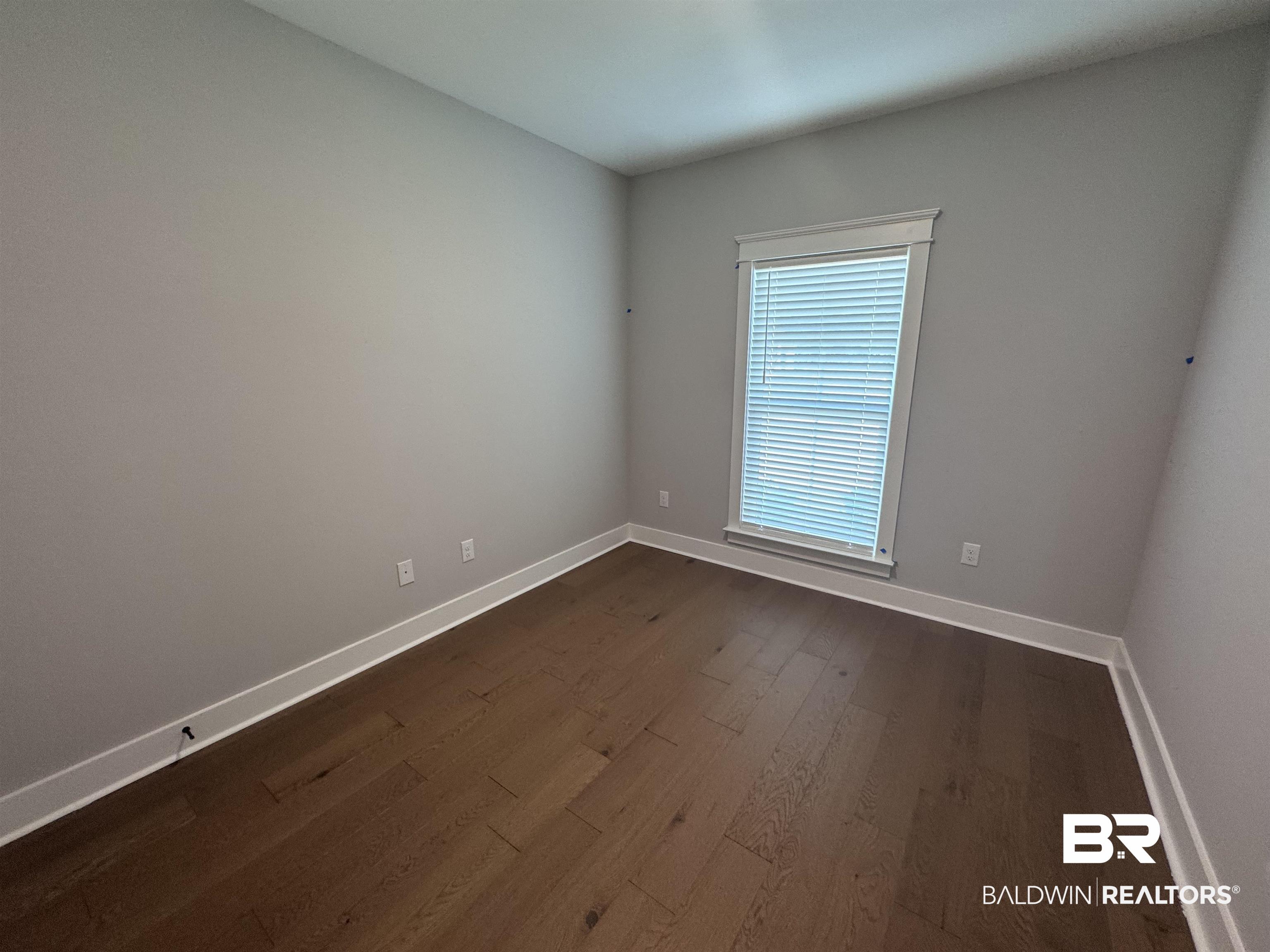 27371 Patch Pl Loop Daphne, AL 36526 - Photo 37 of 63 Empty room with dark wood-style flooring and baseboards
