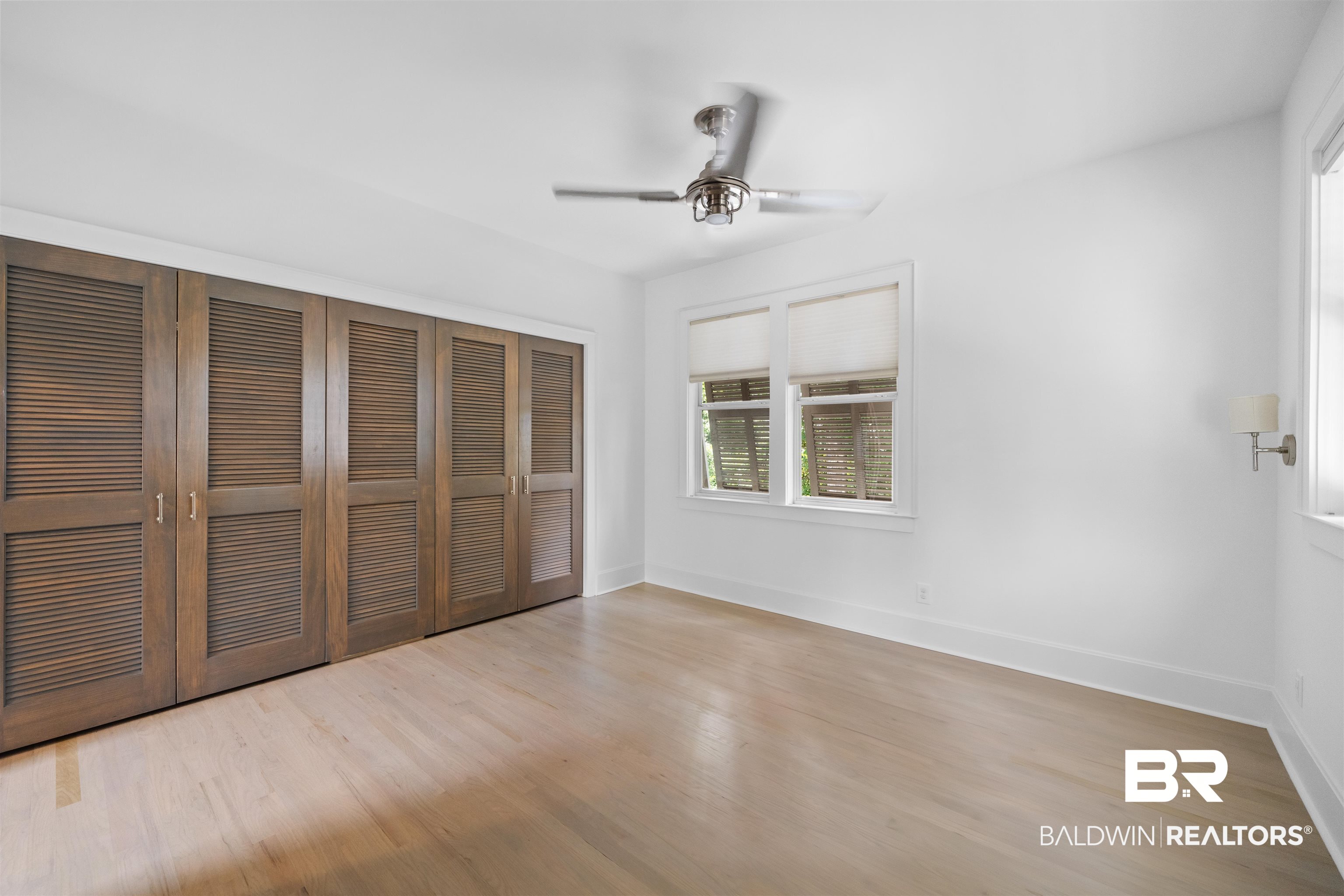 106 White Avenue Fairhope, AL 36532 - Photo 20 of 35 Unfurnished bedroom featuring wood finished floors, a closet, and ceiling fan