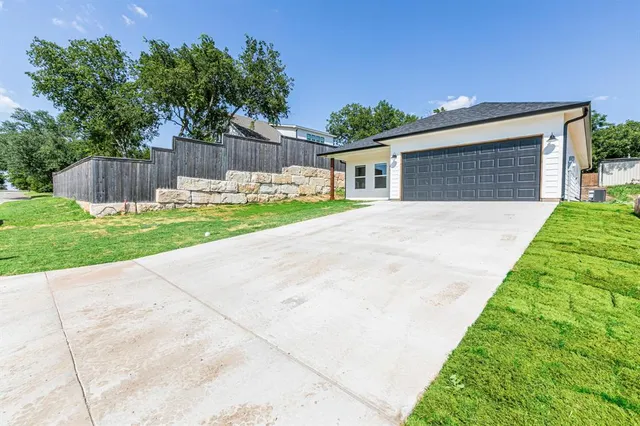 a view of backyard of house with green space