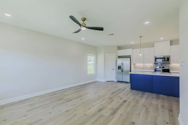 a view of kitchen with refrigerator and window