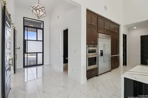 a living room with furniture and kitchen view