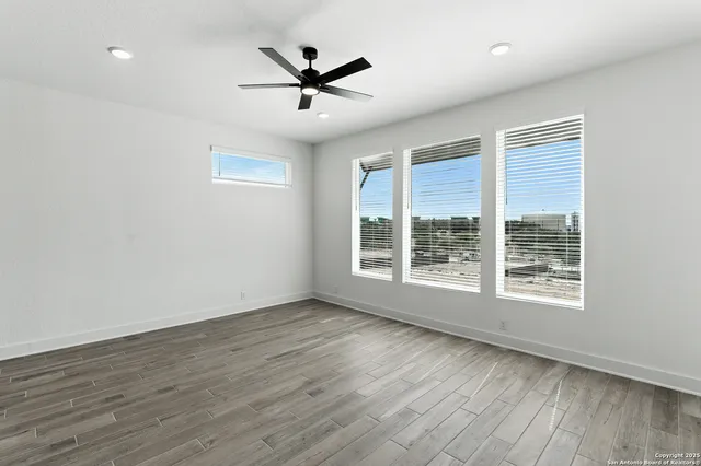 wooden floor in an empty room with a window