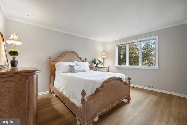 a living room with furniture a flat screen tv and a floor to ceiling window