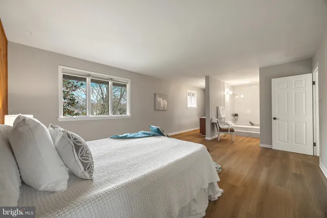 a bedroom with a bed and a table