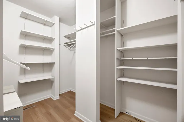 a view of walk in closet with empty racks