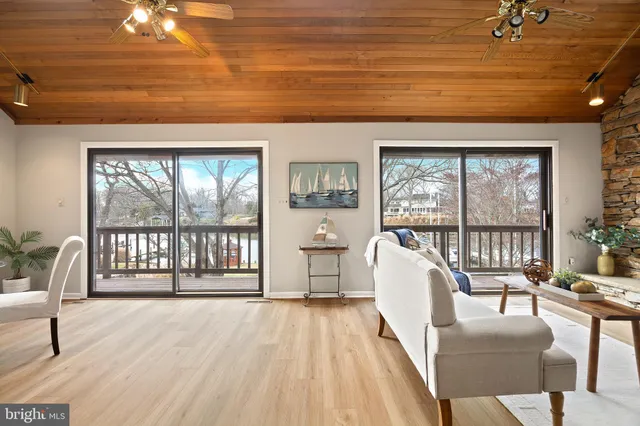 a dining room with furniture a chandelier and wooden floor