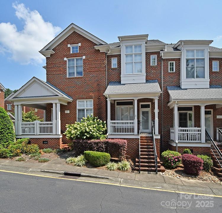 front view of a brick house with a yard