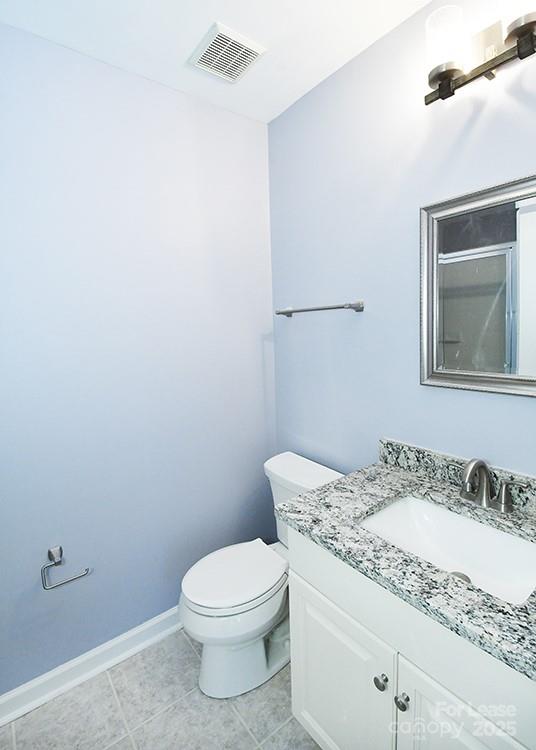 4939 South Hill View Drive Charlotte, NC 28210 - Photo 14 of 24 a bathroom with a granite countertop sink a toilet and mirror