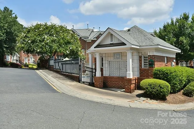 a view of a white house with a large windows and a yard