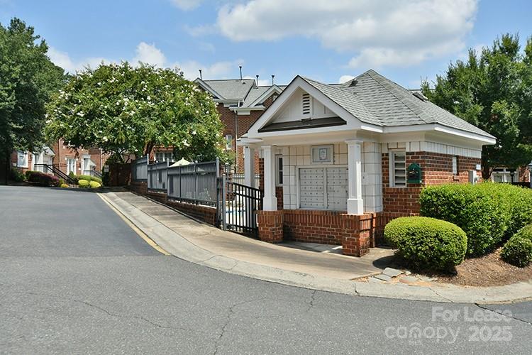 4939 South Hill View Drive Charlotte, NC 28210 - Photo 22 of 24 a view of a white house with a large windows and a yard