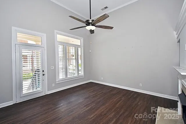 a view of a room with wooden floor and fan