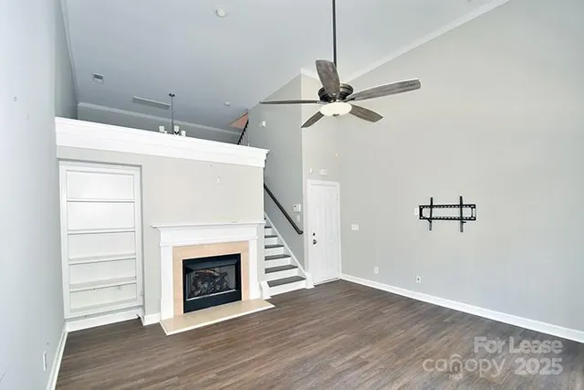 a view of a livingroom with wooden floor a fireplace