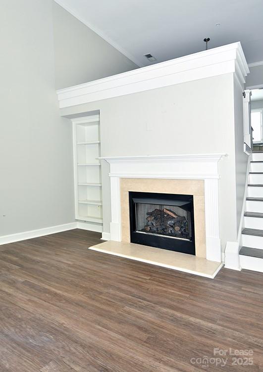 4939 South Hill View Drive Charlotte, NC 28210 - Photo 6 of 24 a view of an empty room with wooden floor fireplace and a window