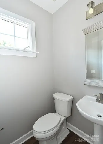 a white toilet sitting next to a bathroom sink