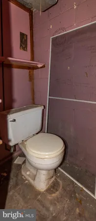 a white toilet sitting next to a bathroom sink
