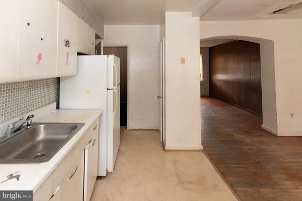 a kitchen with a sink and refrigerator