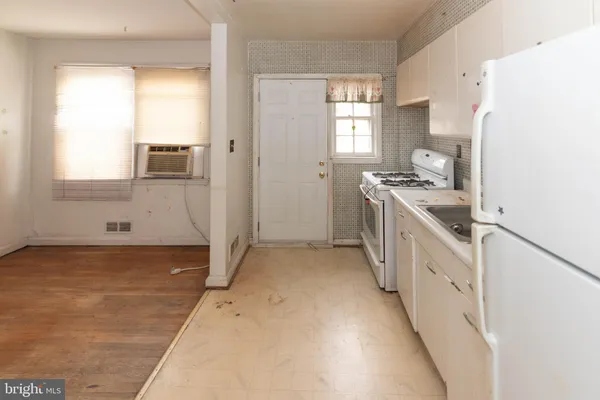a kitchen with granite countertop a sink stove and refrigerator