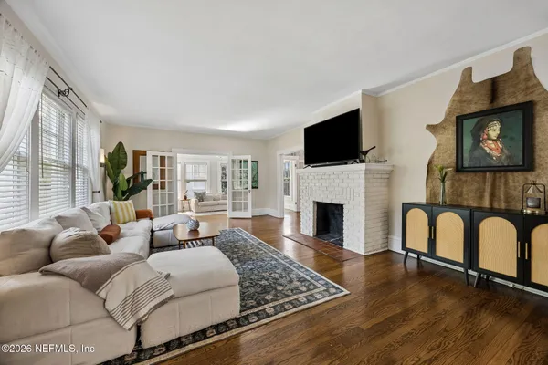 a living room with furniture a fireplace and a flat screen tv