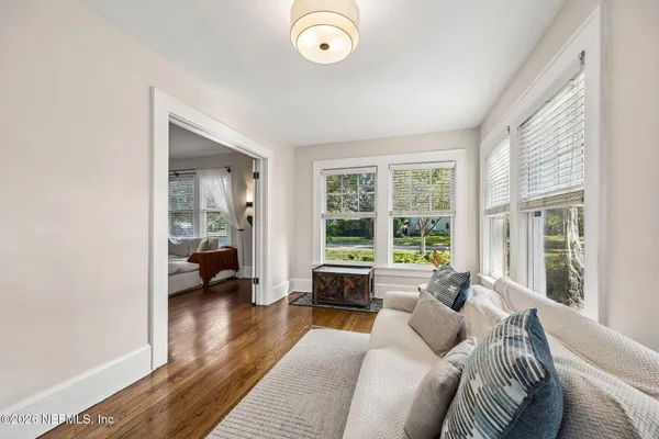 a view of a dining room with furniture window and wooden floor