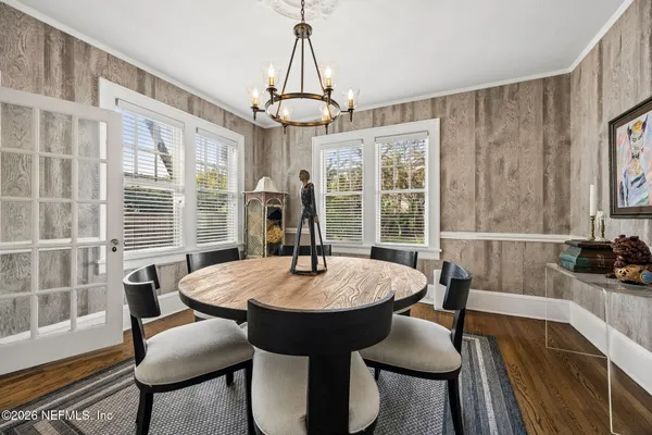 a dining room with furniture and window