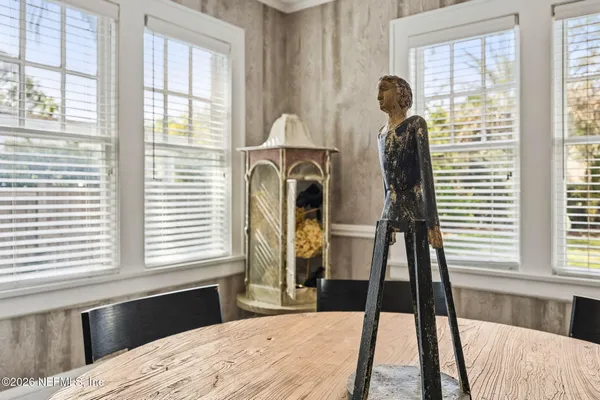 a dining room with furniture window entryway and wooden floor