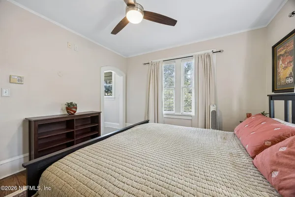 a view of a hallway with wooden floor and closet area