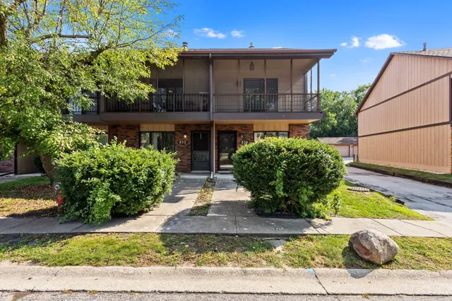 a view of a house with a yard and a garden