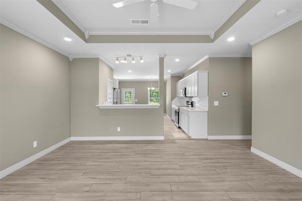 1011 Southeast County Road Corsicana, TX 75109 - Photo 5 of 40 a view of a living room a kitchen and a chandelier