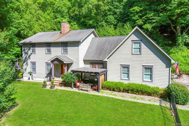 a view of a house with a yard and furniture