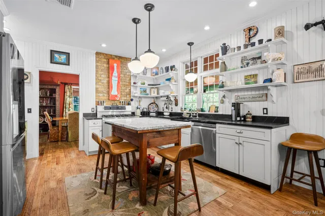 a large kitchen with a table and chairs