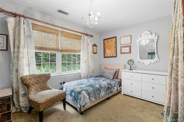 a bedroom with a large bed and a dresser