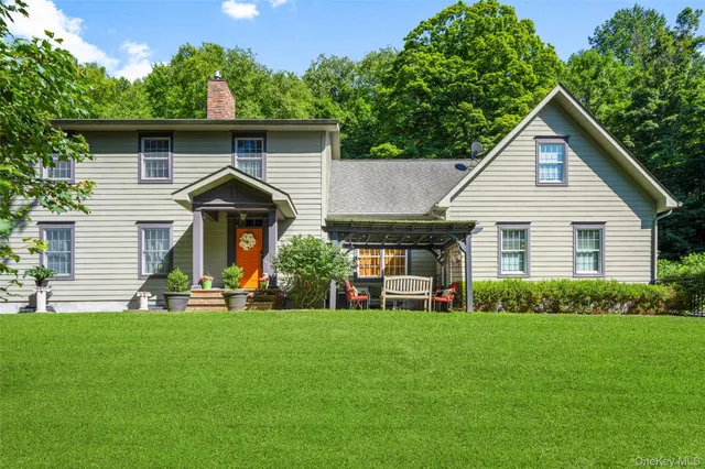 a front view of house with a garden